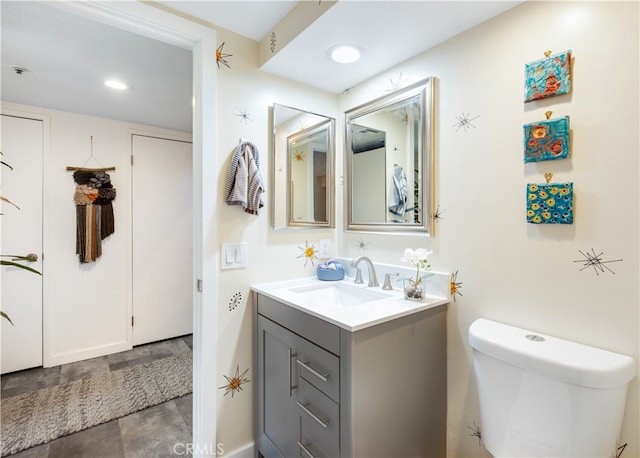 bathroom featuring vanity and toilet