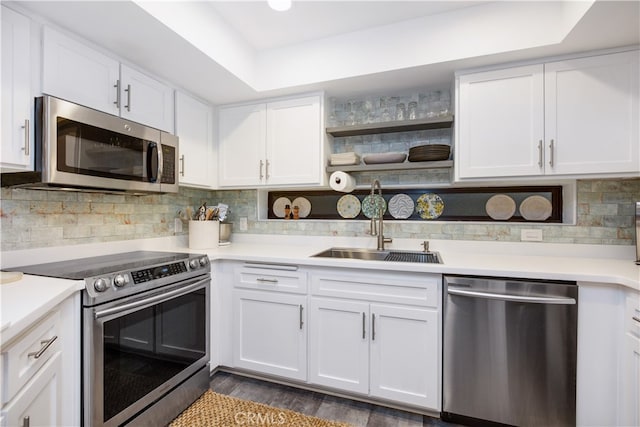 kitchen featuring dark hardwood / wood-style floors, stainless steel appliances, backsplash, sink, and white cabinets