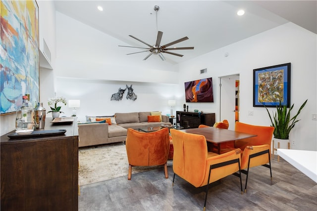 living room featuring ceiling fan, vaulted ceiling, and dark hardwood / wood-style flooring