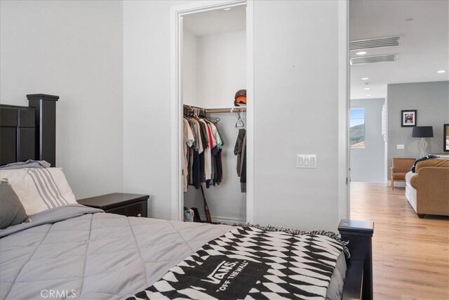 bedroom featuring wood-type flooring and a closet