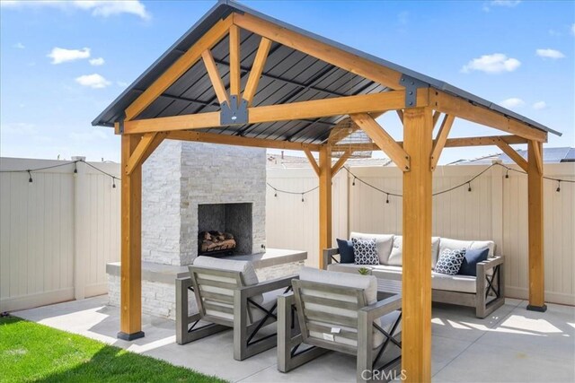 view of patio / terrace with an outdoor living space with a fireplace