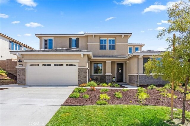 view of front of house with a front yard and a garage