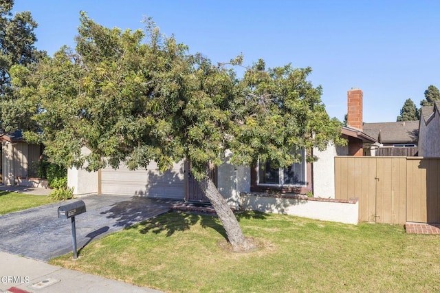 obstructed view of property featuring a front lawn