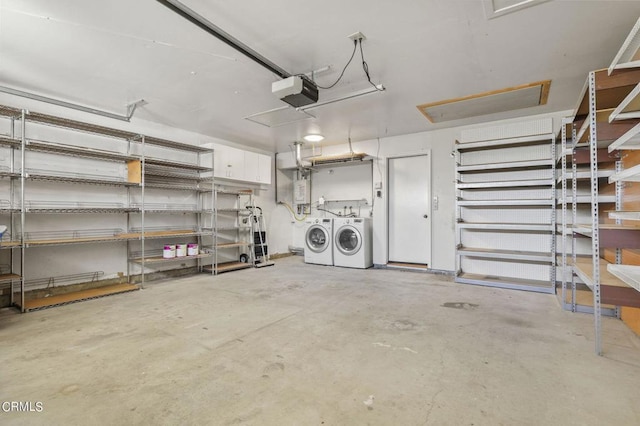 garage featuring separate washer and dryer and a garage door opener