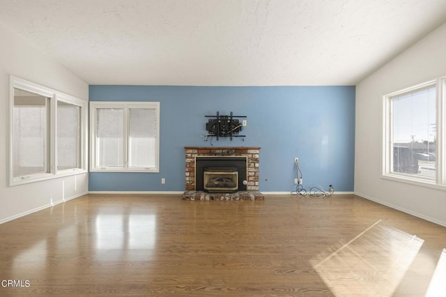 unfurnished living room featuring a fireplace and hardwood / wood-style floors