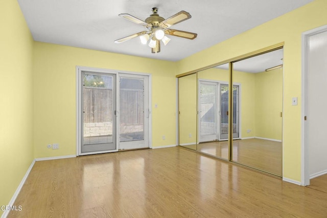 spare room with hardwood / wood-style floors and ceiling fan