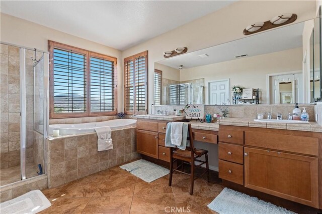 bathroom featuring tile patterned floors, vanity, and separate shower and tub