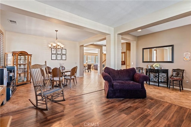 living room featuring a notable chandelier and wood-type flooring