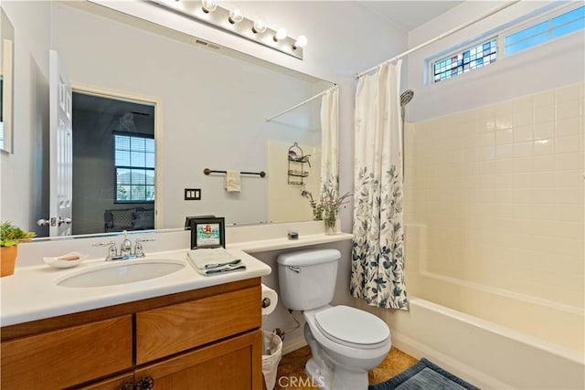 full bathroom featuring vanity, toilet, and shower / bathtub combination with curtain