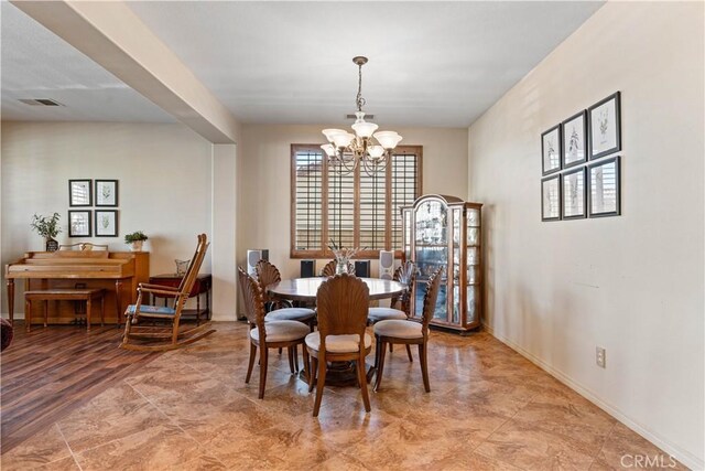 dining space with light wood-type flooring and a chandelier