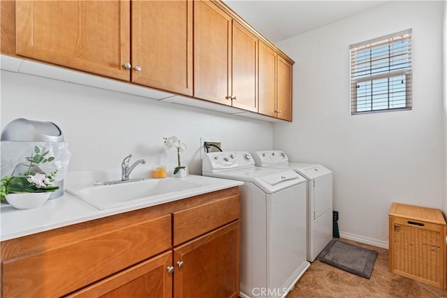 laundry area with cabinets, independent washer and dryer, and sink