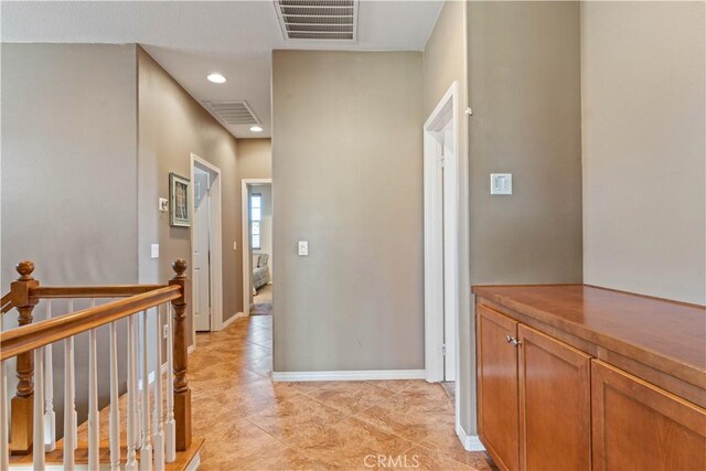 hall featuring light tile patterned floors