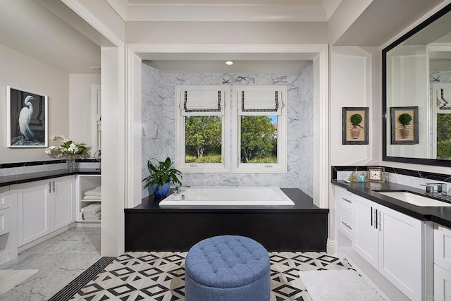 bathroom featuring vanity and a washtub