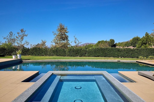 view of pool with an in ground hot tub