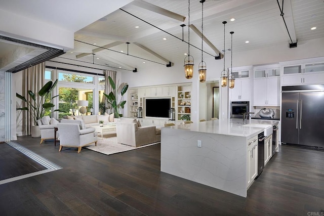 kitchen featuring beamed ceiling, wooden ceiling, white cabinetry, pendant lighting, and stainless steel appliances