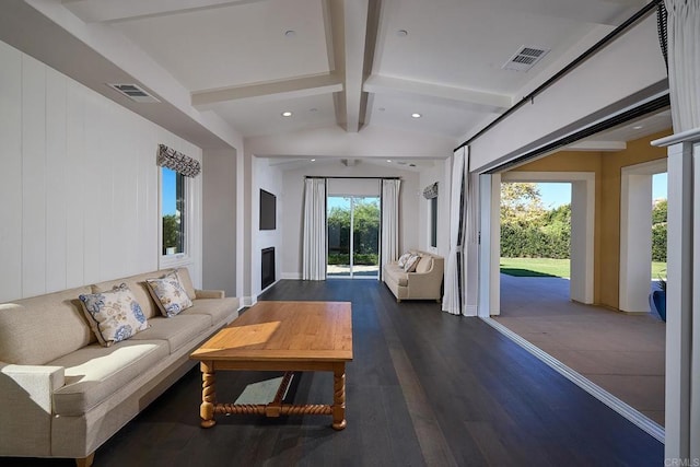 living room featuring dark hardwood / wood-style floors and vaulted ceiling with beams