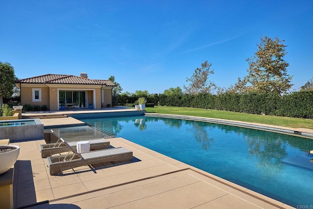 view of swimming pool featuring an in ground hot tub and a patio