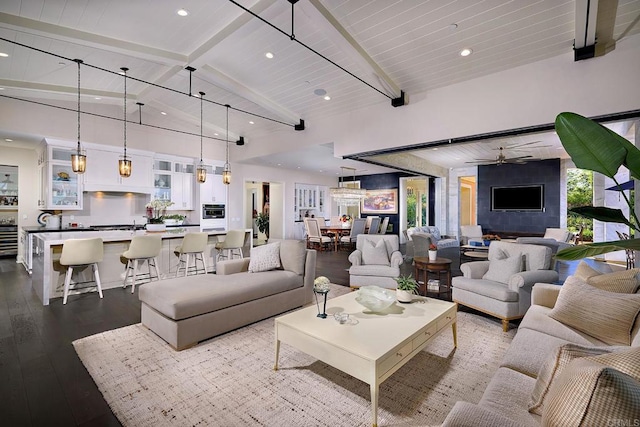 living room with dark wood-type flooring, high vaulted ceiling, ceiling fan, wooden ceiling, and beam ceiling