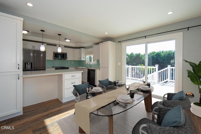 dining space with dark wood-type flooring and sink