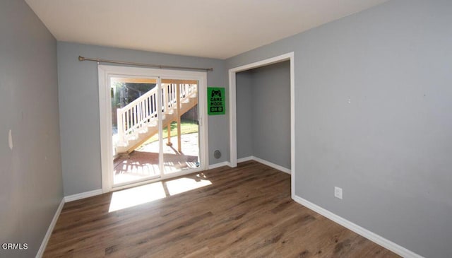 spare room with dark hardwood / wood-style flooring