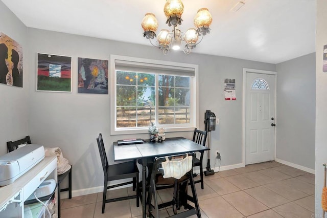 tiled dining area featuring a notable chandelier