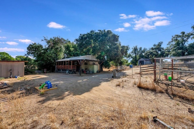 view of yard with an outbuilding and a rural view