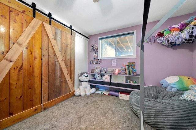 interior space featuring carpet and a barn door