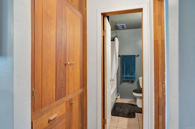 bathroom featuring tile patterned floors and toilet