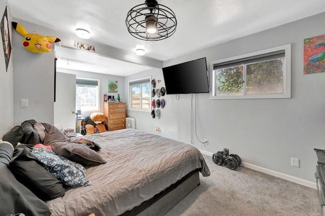 bedroom with light colored carpet and radiator