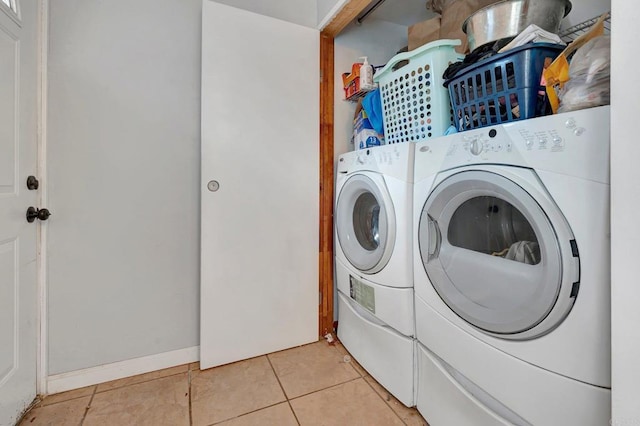 laundry area featuring light tile patterned floors and washer and dryer