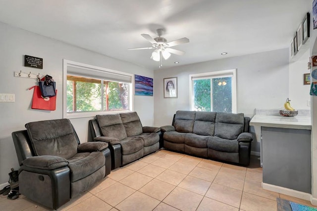 living room with light tile patterned floors, plenty of natural light, and ceiling fan