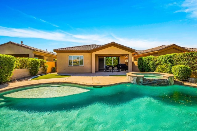 view of swimming pool featuring a patio and an in ground hot tub