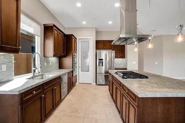 kitchen featuring a kitchen island, stainless steel appliances, sink, pendant lighting, and tasteful backsplash