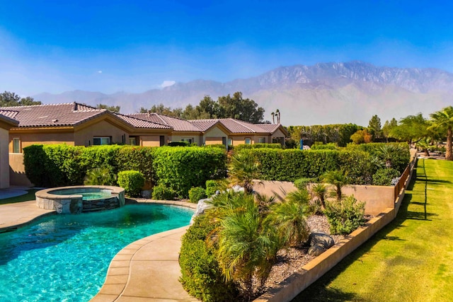 view of swimming pool with an in ground hot tub and a mountain view