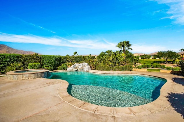 view of swimming pool featuring a patio and an in ground hot tub