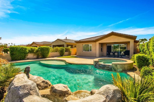 view of swimming pool featuring a patio and an in ground hot tub