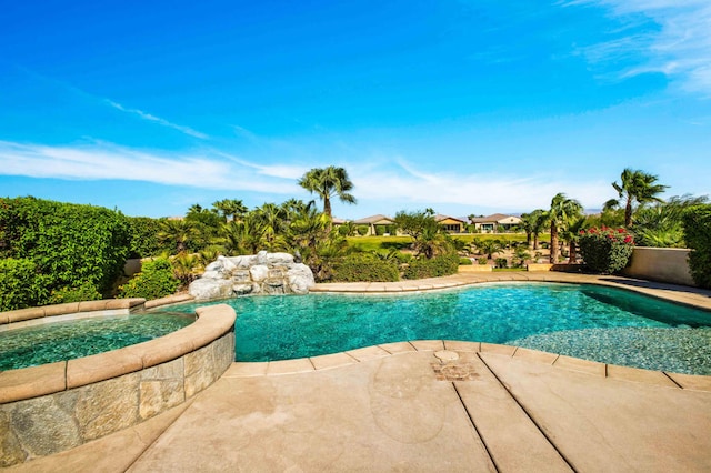 view of swimming pool with a patio and an in ground hot tub