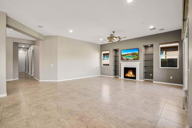 unfurnished living room with built in features and light tile patterned floors