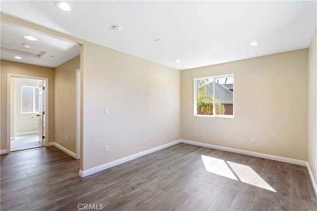 spare room featuring dark wood-type flooring