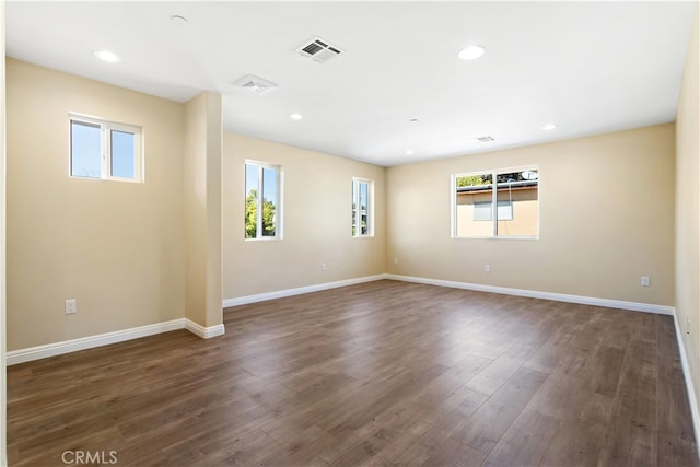 spare room featuring dark hardwood / wood-style flooring