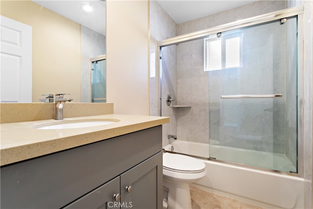 full bathroom featuring vanity, combined bath / shower with glass door, and toilet