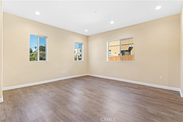 unfurnished room featuring hardwood / wood-style flooring