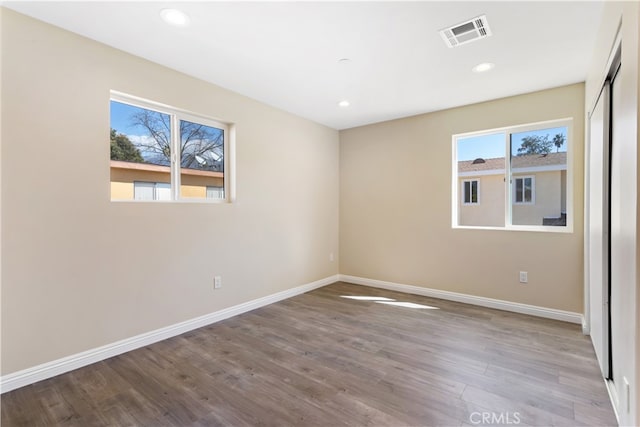 unfurnished room featuring a healthy amount of sunlight and light wood-type flooring