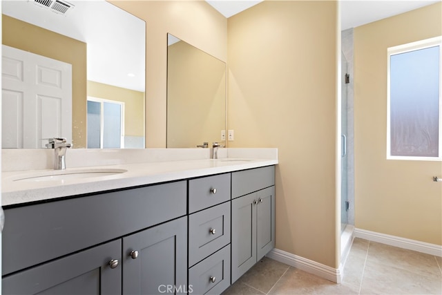 bathroom featuring vanity, tile patterned flooring, and a shower with door