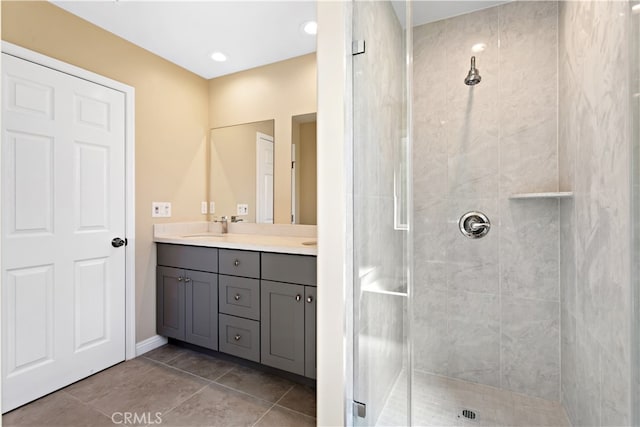 bathroom with vanity, a shower with shower door, and tile patterned flooring