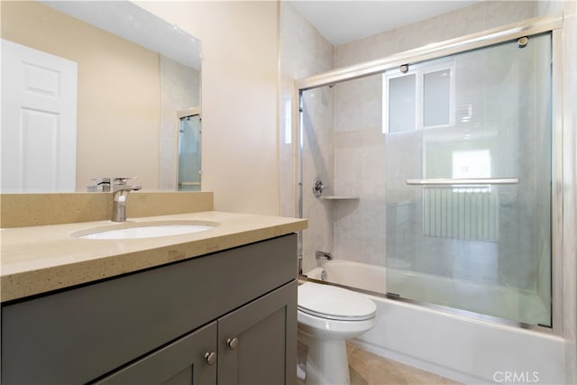 full bathroom with vanity, enclosed tub / shower combo, toilet, and tile patterned floors