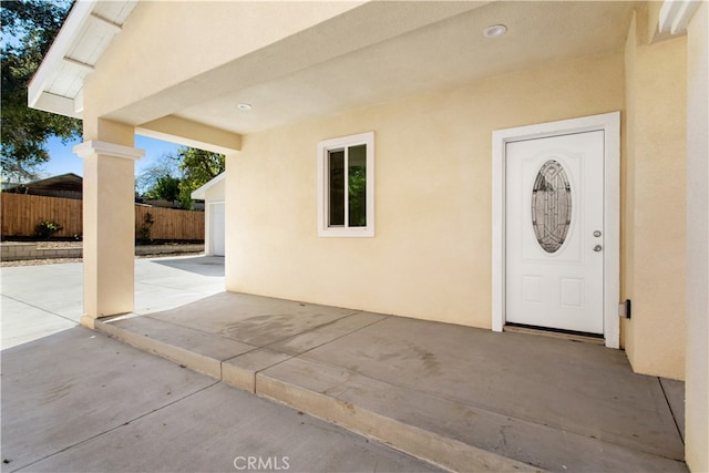 view of exterior entry featuring a patio area