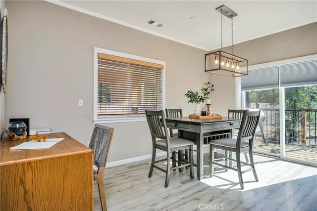 15425 Graham St, Middletown, CA 95461 - dining room with light wood-type flooring, visible vents, crown molding, and baseboards