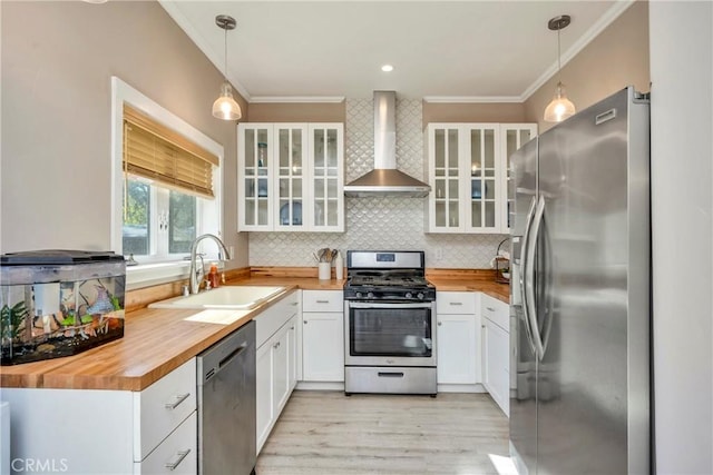 15425 Graham St, Middletown, CA 95461 - kitchen featuring wall chimney range hood, butcher block countertops, a sink, and appliances with stainless steel finishes