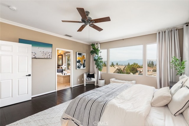 bedroom with ceiling fan, dark hardwood / wood-style floors, ensuite bath, a mountain view, and ornamental molding